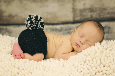 newborn on rug